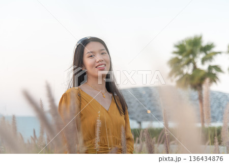 Fashionable Young Asian Woman in Yellow Outfit Outside Louvre Abu Dhabi United Arab Emirates Fashionable Young Asian Woman in Yellow Outfit Outside Louvre Abu Dhabi United Arab Emirates 136434876