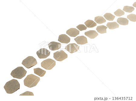 Hexagonal stones are laid out in a curved line. The stones vary in size and shape, and they are placed on a clear background, showing their arrangement and design clearly Hexagonal stones are laid out in a curved line. The stones vary in size and shape, and they are placed on a clear background, showing their arrangement and design clearly 136435712