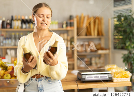 Female customer chooses beer 136435771
