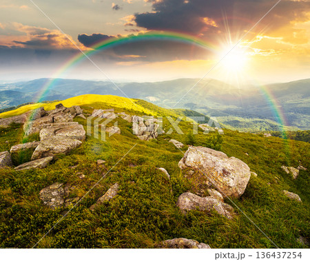 mountain landscape in summer with rocks at sunset. green grass under blue sky in dramatic evening light. alpine meadow and rolling hills with boulders. timeless nostalgia book cover with rainbow mountain landscape in summer with rocks at sunset. green grass under blue sky in dramatic evening light. alpine meadow and rolling hills with boulders. timeless nostalgia book cover with rainbow 136437254