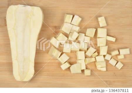 Chopped and halved parsnip on wooden board Chopped and halved parsnip on wooden board 136437811