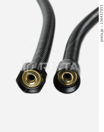 Black shower hose is insulated on a white background. Closeup. Black shower hose is insulated on a white background. Closeup. 136437951