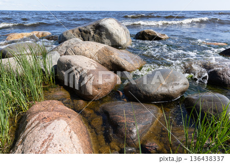 Shoreline landscape photo of Ladoga lake with wet stones Shoreline landscape photo of Ladoga lake with wet stones 136438337
