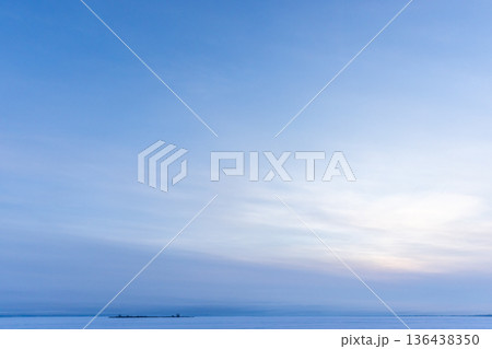 A tranquil seascape captures a sunrise over a frozen sea 136438350