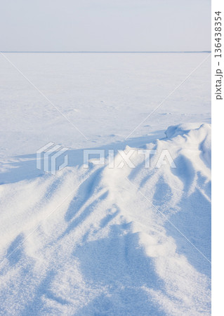 A vast snow covered frozen sea stretches to the horizon 136438354