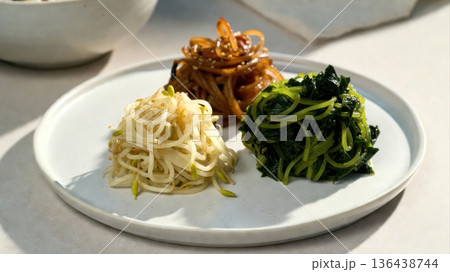 Korean banchan trio bean sprouts seaweed salad and pickles 136438744
