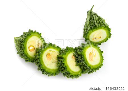 Fresh bitter gourd Bitter cucumber or bitter melon with cut slice isolated on a white background. Fresh bitter gourd Bitter cucumber or bitter melon with cut slice isolated on a white background. 136438922