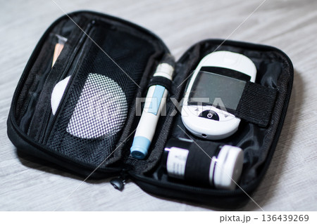 Organized diabetes testing tools prepared for easy use during daily travel and wellness routines 136439269