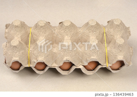 Ten brown eggs in a cardboard carton 136439463