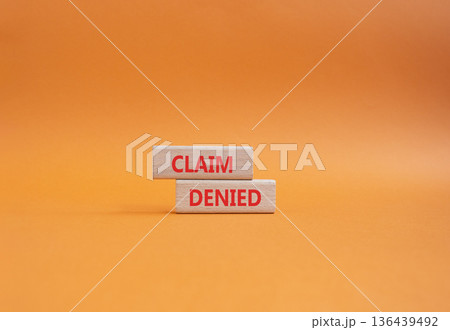 Claim denied symbol. Wooden blocks with words Claim denied. Beautiful orange background. Business and Claim denied concept. Copy space. Claim denied symbol. Wooden blocks with words Claim denied. Beautiful orange background. Business and Claim denied concept. Copy space. 136439492