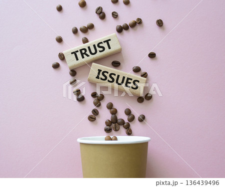 Trust Issues symbol. Wooden blocks with words Trust Issues. Beautiful pink background with coffee cup and coffee beans. Business and Trust Issues concept. Copy space. Trust Issues symbol. Wooden blocks with words Trust Issues. Beautiful pink background with coffee cup and coffee beans. Business and Trust Issues concept. Copy space. 136439496