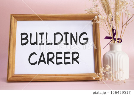 Building Career symbol. Concept words Building Career on beautiful wooden picture frame. Beautiful pink background with flower vase. Business and Building Career concept. Copy space. Building Career symbol. Concept words Building Career on beautiful wooden picture frame. Beautiful pink background with flower vase. Business and Building Career concept. Copy space. 136439517