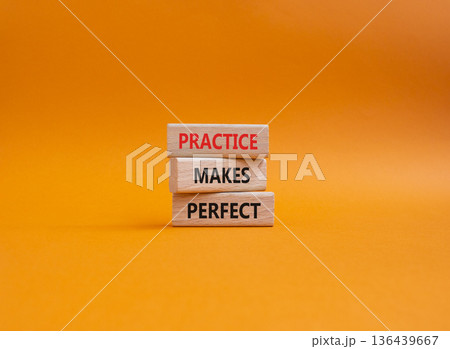Practice Makes Perfect symbol. Wooden blocks with words Practice Makes Perfect. Beautiful orange background. Business and Practice Makes Perfect concept. Copy space. 136439667