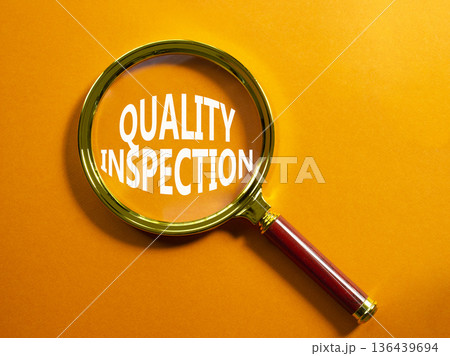 Quality Inspection symbol. Magnifying Glass with words Quality Inspection. Beautiful orange background. Business and Quality Inspection concept. Copy space. Quality Inspection symbol. Magnifying Glass with words Quality Inspection. Beautiful orange background. Business and Quality Inspection concept. Copy space. 136439694