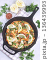 Delicious haddock fish piccata with lemon and capers in cast iron pan, vertical, top view 136439993