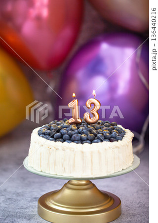 Blueberry birthday cake with number candels 13 for teenager celebration 136440216