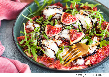 Delicious fresh fig carpaccio with burrata or stracciatella or mozzarella cheese and arugula salad 136440236