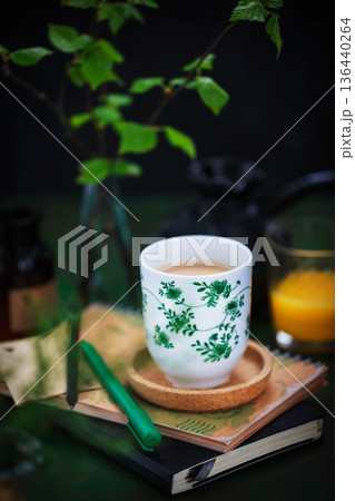 Cozy ceramic cup of cofee on spring background Cozy ceramic cup of cofee on spring background 136440264