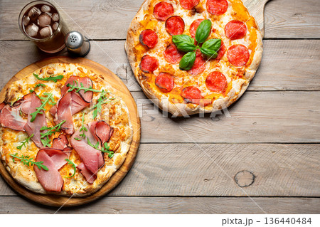 Two Italian pizza on wooden background 136440484