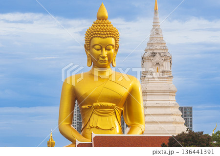 A large seated Buddha or Buddha Dhammakaya Dhepmongkol at Paknam Phasi Charoen temple on a blue sky day. A large seated Buddha or Buddha Dhammakaya Dhepmongkol at Paknam Phasi Charoen temple on a blue sky day. 136441391