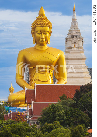 A large seated Buddha or Buddha Dhammakaya Dhepmongkol at Paknam Phasi Charoen temple on a blue sky day. 136441392