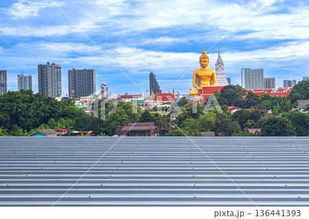 A large seated Buddha or Buddha Dhammakaya Dhepmongkol at Paknam Phasi Charoen temple on a blue sky day. 136441393