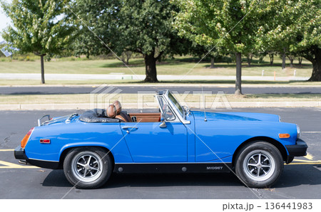 Chicago, Illinois, USA - September 08, 2024: 1975 MG Midget blue retro convertible car, corner view. Retro car. Retro 1975 MG Midget blue car. 1975 MG Midget blue at Chicago Chicago, Illinois, USA - September 08, 2024: 1975 MG Midget blue retro convertible car, corner view. Retro car. Retro 1975 MG Midget blue car. 1975 MG Midget blue at Chicago 136441983