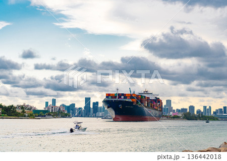 Miami, Florida, USA - June 07, 2024: Container ship. Shipping logistics. Cargo ship with container in Miami skyline. Freight container loaded on cargo vessel in Miami. Cargo ship leaving harbor Miami, Florida, USA - June 07, 2024: Container ship. Shipping logistics. Cargo ship with container in Miami skyline. Freight container loaded on cargo vessel in Miami. Cargo ship leaving harbor 136442018