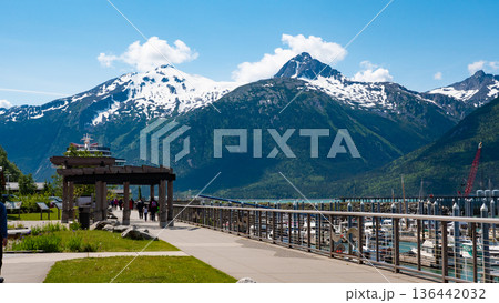 Skagway, Alaska, USA - July 07, 2019: Small boat harbor. Mountain landscape with snowy peaks. Landscape of Alaska, Skagway. Scenic landscape with mountain of Small boat harbor 136442032