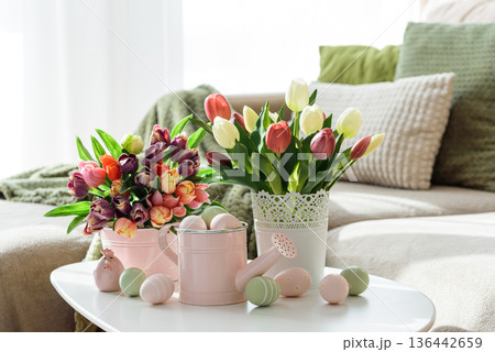 Easter Table with Tulip Bouquets, Eggs and Festive Decor. Cozy Spring Arrangement 136442659