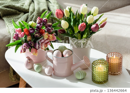 Easter Table with Tulip Bouquets, Eggs, Candles and Festive Decor. Cozy Spring Arrangement 136442664