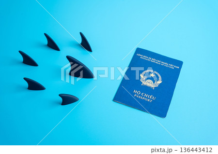 Vietnamese passport and shark fins heading towards it. Pursuit of citizenship. Migration trends, and citizenship challenges. High requirements and bureaucracy for residence. Migration problem. Vietnamese passport and shark fins heading towards it. Pursuit of citizenship. Migration trends, and citizenship challenges. High requirements and bureaucracy for residence. Migration problem. 136443412
