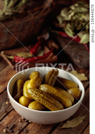 Homemade canned gherkins on a rustic wooden background. 136444879