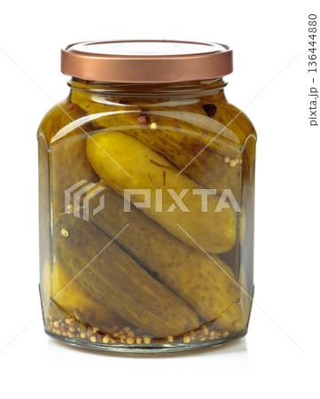 Homemade pickled cucumbers in a glass jar isolated on a white background. 136444880