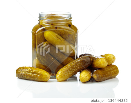 Homemade pickled cucumbers in a glass jar isolated on a white background. 136444883