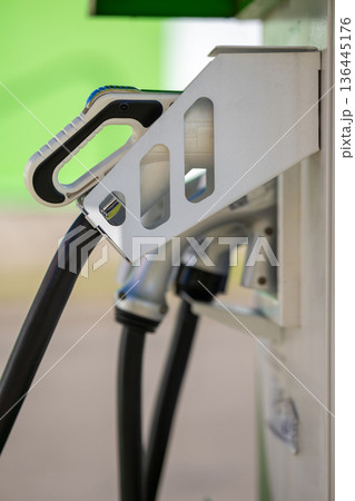 Electric vehicle charging connector at a station 136445176