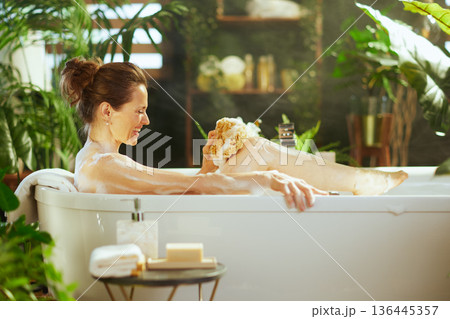 Smiling Woman\'s Soothing Leg Wash Ritual 136445357