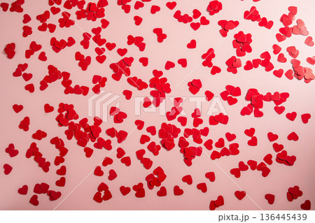 Valentine Day background with red hearts confetti over pink background. St. Valentine's Day love concept, flat lay Valentine Day background with red hearts confetti over pink background. St. Valentine's Day love concept, flat lay 136445439