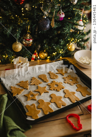 Holiday background. Uncooked raw Christmas gingerbread cookies on baking tray, lifestyle 136445461