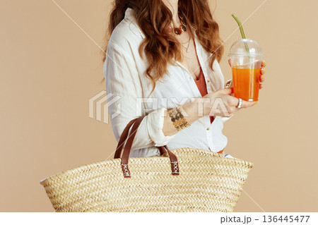 Trendy woman in blouse and shorts on beige 136445477