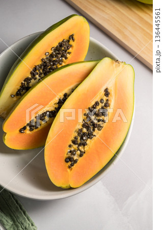 Papaya exotic fruit halves on plate. Healthy vegan food. 136445561