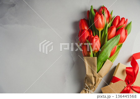Mothers' day. Red tulips with gift box. Easter holiday. Bright background, copy space. 136445568