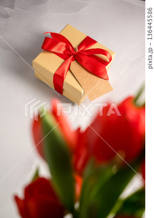 Mothers' day. Red tulips with gift box. Easter holiday. Bright background Mothers' day. Red tulips with gift box. Easter holiday. Bright background 136445586