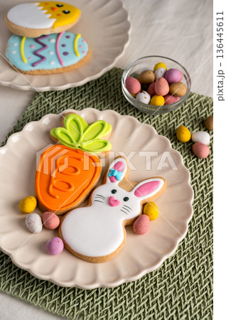 Easter festive colourful cookies bunny, carrot, egg, chick in a plate with egg candies. 136445611