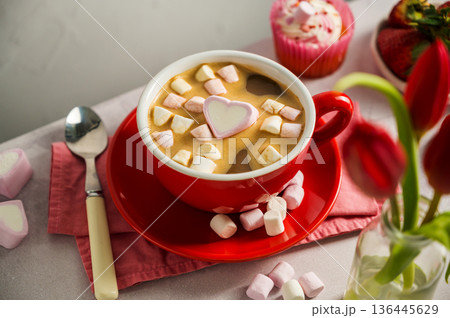 Valentine's Day background. Red cup of coffee with heart shaped marshmallows and ret tulips 136445629
