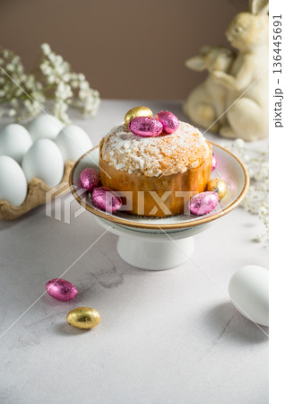Easter spring holiday background. Cake with chocolate easter eggs, gypsophila flowers and bunny Easter spring holiday background. Cake with chocolate easter eggs, gypsophila flowers and bunny 136445691