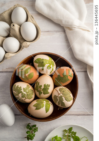 DIY Easter eggs with natural leaves, creating patterns on eggs using plants. Eco friendly colouring easter eggs 136445695