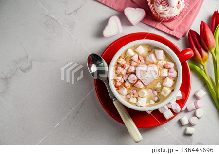 Valentine's Day background. Red cup of coffee with heart shaped marshmallows and ret tulips 136445696