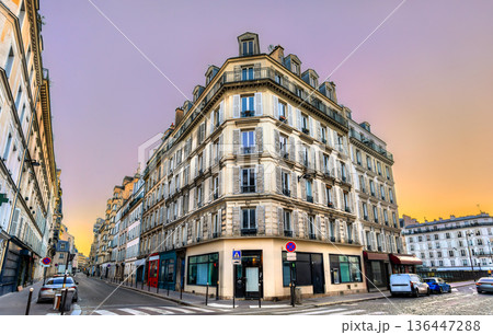 Haussmann corner building at the intersection of Rue des Batignolles and Rue Boursault in Paris 17th district. Historic architecture features balconies and shutters at sunrise Haussmann corner building at the intersection of Rue des Batignolles and Rue Boursault in Paris 17th district. Historic architecture features balconies and shutters at sunrise 136447288