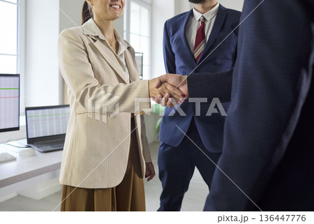 Close up handshake confirming business agreement, colleagues sealing partnership 136447776